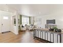 Bright living room with hardwood floors, neutral decor, and large windows for natural light at 22323 E 6Th Pl, Aurora, CO 80018
