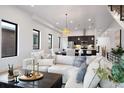 Open-concept living area flowing into kitchen with large windows, modern lighting and comfortable sectional sofa at 19 Washington Ave, Golden, CO 80403