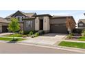 Modern home with attached garage, concrete driveway, and meticulously kept landscaping at 6530 Barnstead Dr, Castle Pines, CO 80108