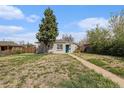 Charming single-story home with brick accents, a well-manicured lawn, and a welcoming teal front door at 3640 N Saint Paul St, Denver, CO 80205