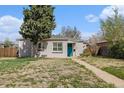 Charming single-story home with brick accents, a well-manicured lawn, and a welcoming teal front door at 3640 N Saint Paul St, Denver, CO 80205