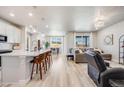 Bright, open-concept living space featuring a modern kitchen, dining area, and comfortable living room at 13437 Waterthrush St, Parker, CO 80134