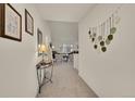 Well-lit hallway with decorative wall hangings leading to a cozy living space at 16773 W 61St Ln, Arvada, CO 80403