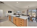 Bright, open kitchen with a large island, modern appliances, and dining area perfect for entertaining at 16773 W 61St Ln, Arvada, CO 80403