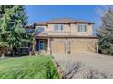 Stunning two-story home featuring a stone facade and a spacious two car driveway at 10914 W Coco Pl, Littleton, CO 80127