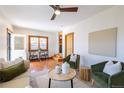 Spacious living room with wood floors and a table with seating near the stained glass front door at 1836 S Grant St, Denver, CO 80210