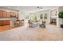 Open concept living room featuring hardwood floors, fireplace, and seamless flow to the kitchen at 15414 Xenia Ct, Thornton, CO 80602