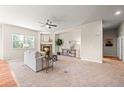 Spacious living room with a cozy fireplace, neutral tones, and ample natural light at 15414 Xenia Ct, Thornton, CO 80602
