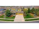 Beautiful two-story home featuring a three-car garage and well-manicured lawn at 25362 E Indore Dr, Aurora, CO 80016