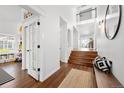 Bright foyer with hardwood floors, white walls, and an open staircase leading to the upper level at 25362 E Indore Dr, Aurora, CO 80016