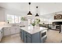 Open kitchen with island, stainless appliances, and attached dining area with lots of windows at 25362 E Indore Dr, Aurora, CO 80016
