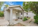 Inviting front porch with decorative supports, manicured landscaping, and clear house number at 113 E Saint Clair Ave, Longmont, CO 80504