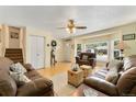 Bright living room featuring hardwood floors, bay window, and comfortable seating at 8475 W 74Th Dr, Arvada, CO 80005