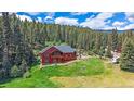 Hilltop home surrounded by lush forest; features deck for enjoying views at 27612 Shadow Mountain Dr, Conifer, CO 80433