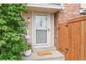Close up of the entrance to 12142B with a white trimmed storm door and welcome mat at 12142 Bannock Cir # B, Denver, CO 80234