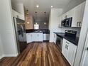 Bright kitchen with stainless steel refrigerator, sleek countertops, and updated appliances at 12753 Ivanhoe St, Thornton, CO 80602