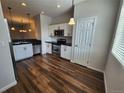 Modern kitchen featuring stainless steel appliances, white cabinets, and stylish pendant lighting at 12753 Ivanhoe St, Thornton, CO 80602