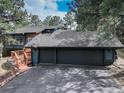 Charming exterior showing a large driveway with a basketball hoop and a two-car garage at 2434 Hearth Dr # C1, Evergreen, CO 80439