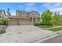 Charming two-story home with a three-car garage, covered entry, and well-manicured front lawn at 5161 Chicory Cir, Brighton, CO 80601