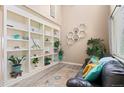 Elegant living room with high ceilings, built-in shelves, and comfortable seating at 5161 Chicory Cir, Brighton, CO 80601