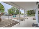Covered front porch featuring white columns, a concrete floor, and a view of the neighborhood at 233 N 10Th Ave, Brighton, CO 80601