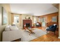 Bright living room featuring a brick fireplace, hardwood floors, and natural light at 588 Newark St, Aurora, CO 80010