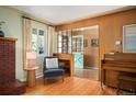 Cozy living room with a brick fireplace, hardwood floors, and a charming interior design at 588 Newark St, Aurora, CO 80010