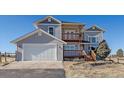 Charming two-story home with a two-car garage and a cozy wooden balcony at 43016 London Dr, Parker, CO 80138