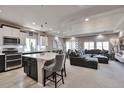 Open-concept living area with a modern kitchen, dining space, and comfortable seating, perfect for entertaining at 10639 Worchester Dr, Commerce City, CO 80022