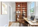 Bright office space featuring custom built-ins, a desk, and a large window at 618 Milwaukee St, Denver, CO 80206