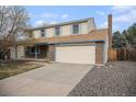 Charming two-story home with brick accents, a large garage, and a well-maintained front yard at 7974 S Pennsylvania Dr, Littleton, CO 80122