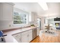 Bright eat-in kitchen featuring white cabinets and stainless steel appliances at 7974 S Pennsylvania Dr, Littleton, CO 80122