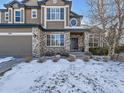 Two story home with a brick and siding exterior, two car garage, and landscaping at 11701 Bent Oaks St, Parker, CO 80138