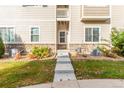 Townhome entrance with stairs, landscaping, and AC units at 1536 Sepia Ave, Longmont, CO 80501