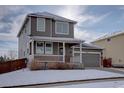 Inviting two-story home featuring a covered front porch and an attached two-car garage at 12218 S Oak Bluff Trl, Parker, CO 80134