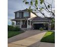 Beautiful two-story home with a well-maintained lawn, long driveway, and attached two-car garage at 12218 S Oak Bluff Trl, Parker, CO 80134