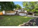 Charming two-story home boasts a well-manicured lawn and two-car garage at 9591 W Florida Pl, Lakewood, CO 80232