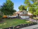 Charming two-story home boasts a well-manicured lawn and two-car garage at 9591 W Florida Pl, Lakewood, CO 80232