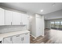 This modern kitchen features shaker cabinets, quartz counters, and stainless appliances at 495 S Dayton St # 1D, Denver, CO 80247