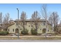 Charming townhouse showcasing its neutral color and detailed architecture surrounded by manicured landscaping at 10148 E 29Th Dr, Denver, CO 80238