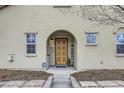 Inviting front entrance featuring a welcoming door, elegant stonework pathway and manicured landscaping at 10148 E 29Th Dr, Denver, CO 80238