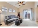Bright living room features vaulted ceiling, neutral tones and a sliding glass door at 10148 E 29Th Dr, Denver, CO 80238