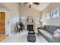 Comfortable living room with a fireplace, vaulted ceiling, lots of windows and neutral-toned decor at 10148 E 29Th Dr, Denver, CO 80238