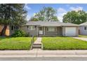 Inviting single-story home with a tidy front yard and a walkway leading to the entrance at 1742 S Forest St, Denver, CO 80222