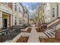 Exterior view of the townhome community, featuring landscaped walkways and beautiful architecture at 30 Garfield St # G, Denver, CO 80206