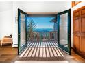Inviting balcony view through open french doors showcasing the scenic landscape and beautiful clear blue skies at 13416 Kuehster Rd, Littleton, CO 80127