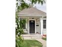 Inviting front porch with bench seating, perfect for enjoying the outdoors at 3365 S Grant St, Englewood, CO 80113