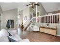 Bright living room featuring high ceilings, open staircase, and hardwood floors at 3853 S Genoa Ct # D, Aurora, CO 80013
