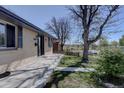 This home features a beautiful lawn, landscaping and fresh exterior paint at 1641 Orchard Dr, Denver, CO 80221