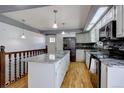 A full kitchen with stainless appliances and an island at 1641 Orchard Dr, Denver, CO 80221